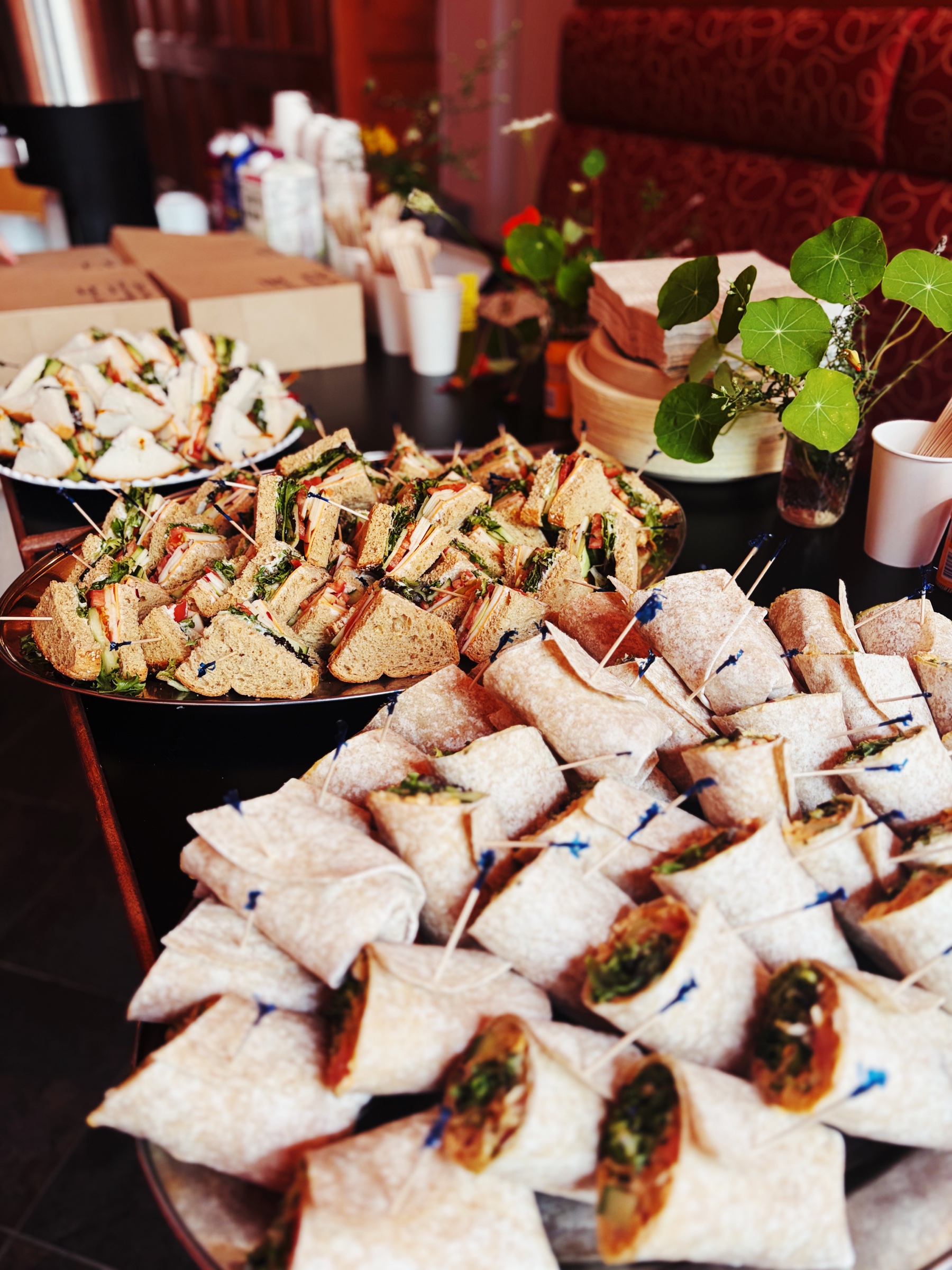 Platters of sandwiches and wraps prepared for an Our Place catering order
